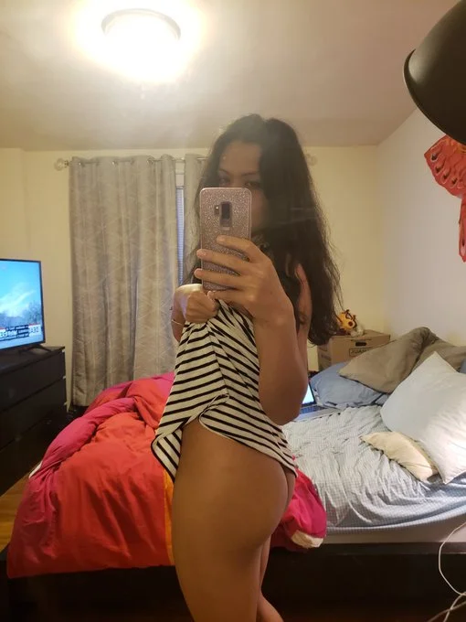 Jojo (@jojo4straight), an Asian amateur onlyfans model picture in bedroom wearing a stripe top