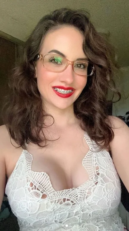 Lacey (@xoxolaceybabe) Braces OnlyFans model sexy picture wearing glasses with red lips and big tits